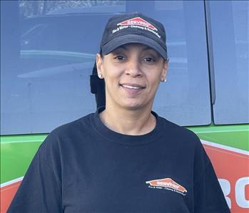 Production Technician, Mel, standing in front of one of our SERVPRO vehicles.
