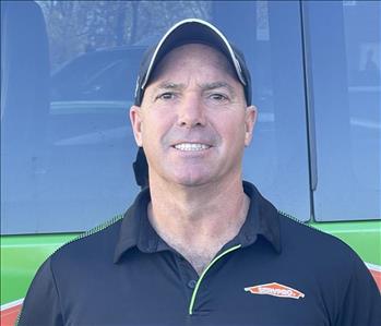SERVPRO of Levittown Owner, Bill Kelly, standing in front a SERVPRO vehicle.