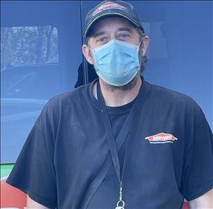 Crew Chief, Rick, standing in front of one of our SERVPRO vehicles.