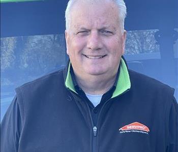 Bill, Business Development Manager, standing in front of one of our SERVPRO vehicles.