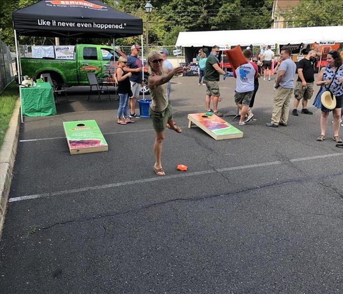 Community members playing on SERVPROs cornhole boards!