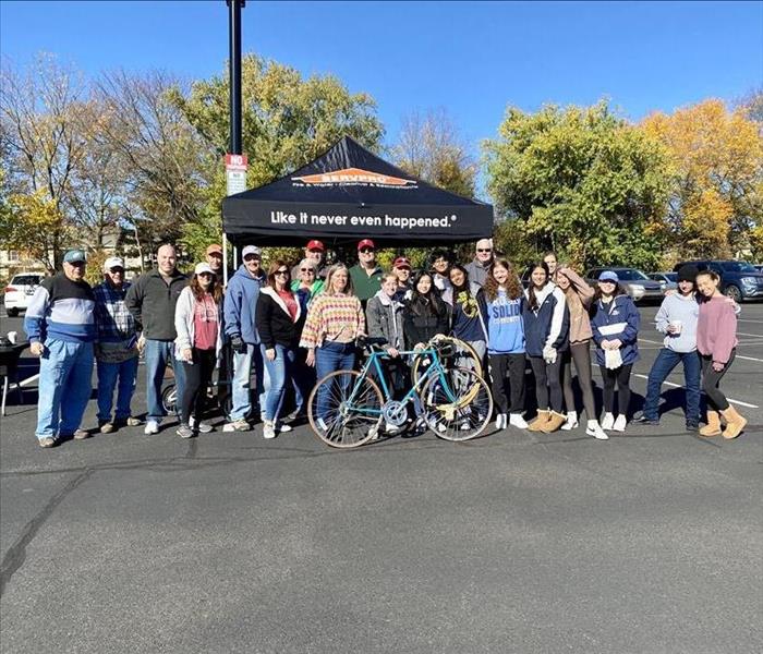 Newtown Rotary Club standing in front of SERVPROs tent at their even, Pedals for Progress